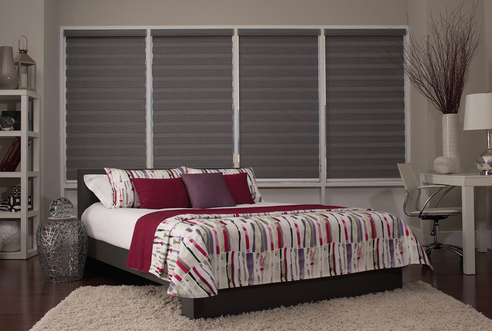 four large dark gray Allure® Transitional Shades behind a bed with dark red, white, and purple Interior Masterpieces® Custom Bedding
