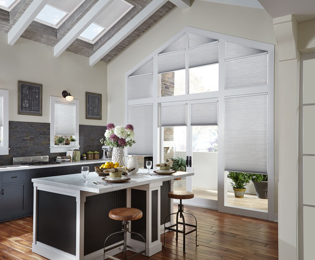 Parasol® Cellular shades with motorized lifting system and specialty shaped Palladian Angle shades along with Motorized Cellular Skylite Shades Several Parasol® Cellular shades in a large wall of windows that come up to a point that have Palladian Angled specialty shaped Cellular shades at the top along with Parasol® motorized shades in the skylights